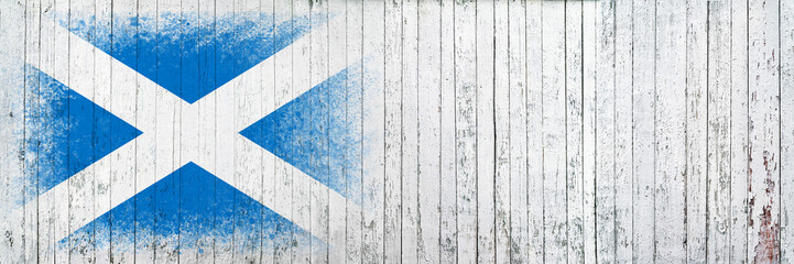 Flag of Scotland. Flag is painted on a white wooden surface. Wooden background. Plywood surface. Copy space. Textured background