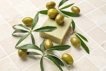 Foto op Plexiglas Soap bar with green olives and plant branches on beige tile background © Pixel-Shot
