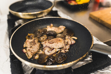 Bolete mushrooms cooked o frying pan with the use of butter. Professional restaurant equipment. Tenderloin dish. High quality photo