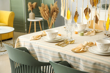 Stylish dinnerware on served table