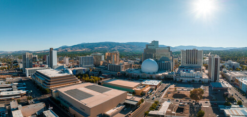 Panoramic aerial view of the city of Reno cityscape in Nevada. Downtown Reno, Nevada, with hotels, casinos and the surrounding High Eastern Sierra foothills. - obrazy, fototapety, plakaty