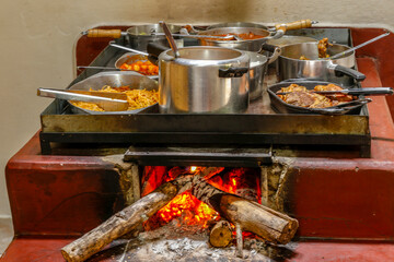 Wood stove cooking a variety of foods in a popular restaurant in Minas Gerais, Brazil. Traditional...