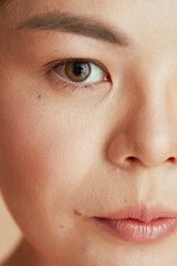 Fototapeta premium Closeup on asian female looking in camera