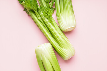 Bunches of fresh celery on pink background, closeup