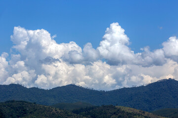 Clouds in dramatic formation over the chain of hills, with blue sky on countryside of Brazil. Space for text