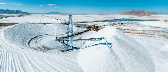 Salt Lake City, Utah landscape with desert salt mining factory at lake Bonneville with piles of white mineral and industrial equipment - obrazy, fototapety, plakaty