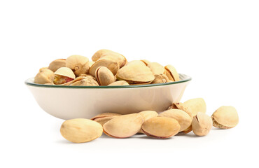 Plate with tasty pistachio nuts isolated on white background