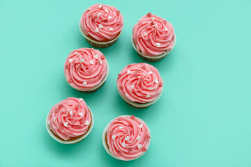 Tasty cupcakes for Valentine's Day on green background