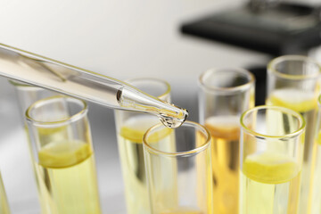 Dropping urine sample for analysis into tube, closeup