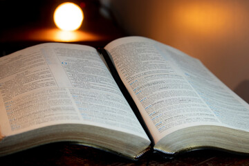 Holy Bible open on a pulpit with lighting in front