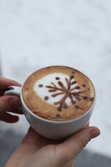 Woman with cup of aromatic coffee outdoors in winter, closeup