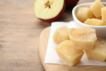 Frozen apple puree cubes and ingredient on wooden table, closeup. Space for text