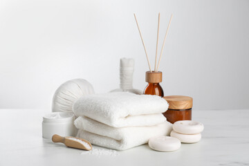 Spa composition with care products on white marble table