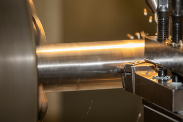 Close up scene the lathe machine finish cut the metal shaft parts by insert tools.