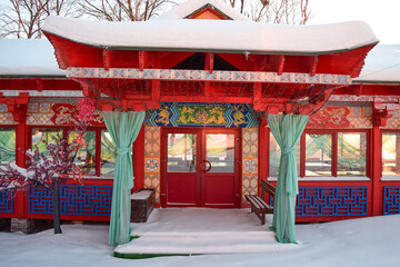 Red Chinese house with patterns and dragons on a winter morning against the background of dawn
