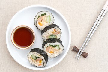Korean Rolled Gimbap, made of rice, cucumber, tuna, carrot, sausage, crab stick and wrapped with seaweed laver. 
