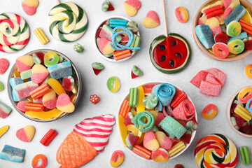 Fototapeta na wymiar Many tasty colorful jelly candies on white table, flat lay