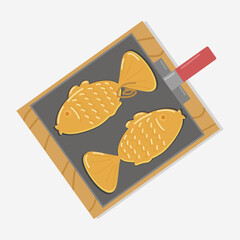 fish-shaped pies with red bean paste in a baking dish on a wooden board