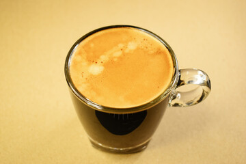 black coffe put on kraft paper, beverage in the morning