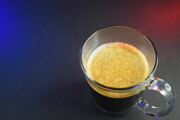 black coffe on black table with neon lights