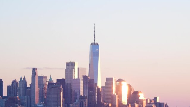 Nyc world trade center tower standing out in downtown skyscrapers in stuning sunlight during sunset, natural light reflecting of of glass, 4k resolution horizontal video.