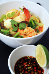 curry food, Chinese, indian and asian food, shrimp mixed with quail egg and vegetables with hot curry souce in white bowl,