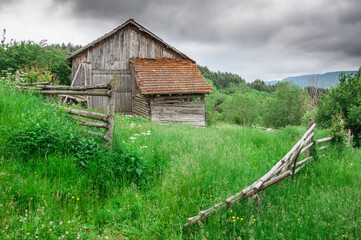 Old wooden house and wooden fence. - 556583806