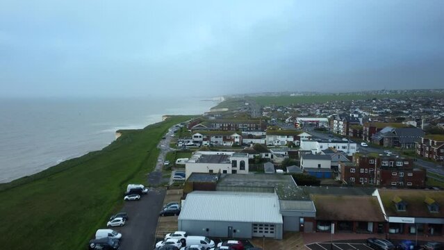 Drone shot houses on cliff edge in Brighton, England. Erosion damage and climate change danger