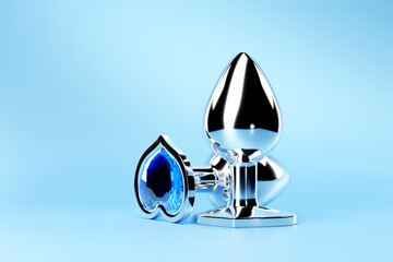 3D illustration.  Silver  butt anal plugs sex toys on  blue background.
