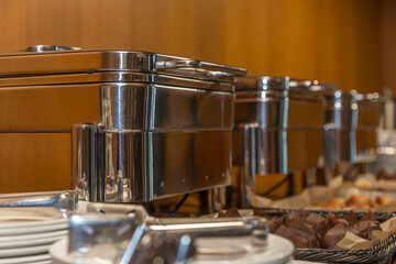 Food warmers for hot dishes on the buffet table. Catering for events. Close-up. Selective focus.