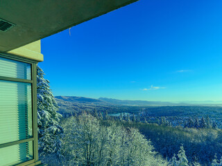 Stunning panoramic winter view over Fraser Valley, BC, Canada, seen from the balcony of a UniverCity Highlands residence on Burnaby Mountain.