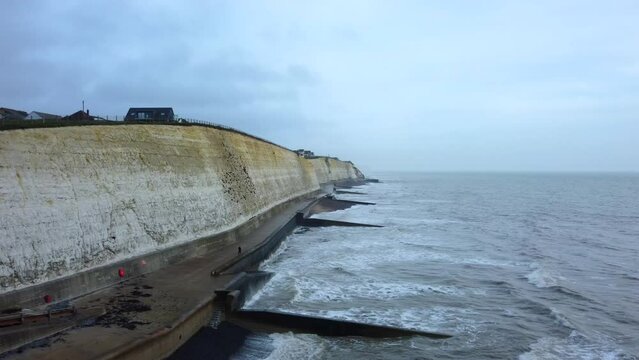 Coastal defences on Brighton beach in England. Groynes jutting into sea