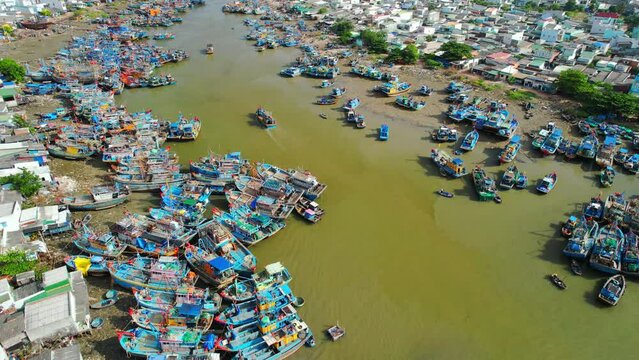 La Gi fishing village seen from above with hundreds of boats anchored along both sides of river to avoid storms near estuary, this is also a large fishing port providing seafood in central Vietnam