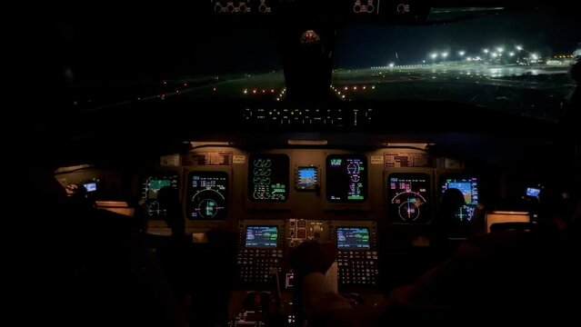 Jet cockpit view in a real flight during night landing at Valencia’s airport. Night light.