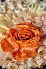 banquet food. cheese and meat sandwiches. decorated food for celebration. cheese and ham tasting. ham in the shape of a rose. close-up of food in the shape of plants. 