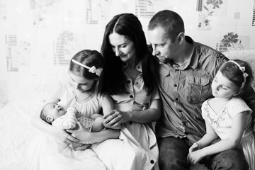 portrait of a happy family with three children. black and white photo