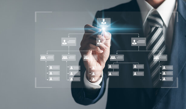 Businessman touching organization chart on virtual interface screen. Business process and workflow automation with flowchart. Hierarchical structure of teams and employees in the company.
