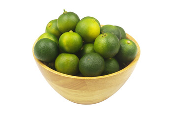 Green limes in wooden bowl isolated on white background.