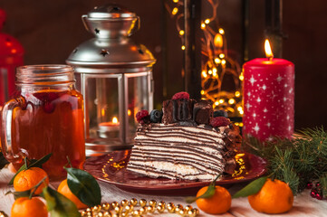 Slice of Christmas cake decorated with holly and berries
