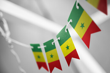 A garland of Senegal national flags on an abstract blurred background