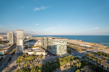 Obraz premium Modern buildings and roars in the coastal residential area of Diagonal Mar in Barcelona, Spain with view to the blue sea and sky
