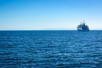 View of the dark blue sea in Greece and a ship in the distance