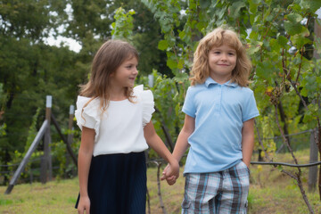 Brother and sister playing outside. Little boy and girl working in the garden. Two happy children in summer park. Kids summer holiday vacation concept. Childrens friendship.