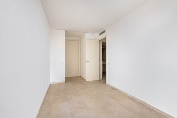 Empty room with tile flooring and newly painted white walls. Repair and construction concept.