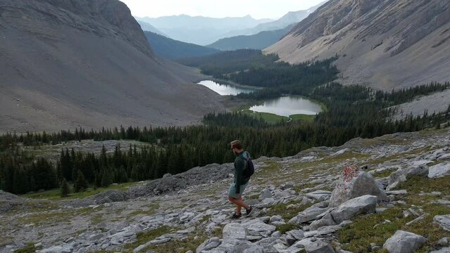 hiker walking down Mountain valley Rockies Kananaskis Alberta Canada
