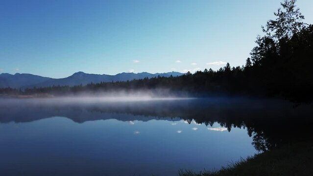 Lake shore mist with mountains and forest Timelapse Enid British Columbia Canada