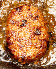 Cutlets are fried in oil in a frying pan.