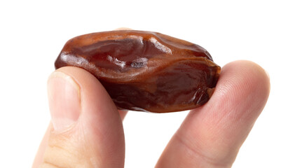 Dried date in hand isolated on white background.