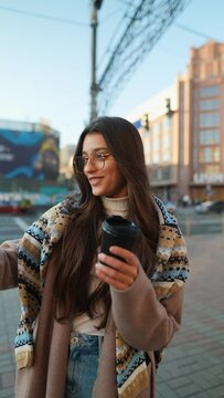 Stylish female traveler taking selfie or video for internet blog.