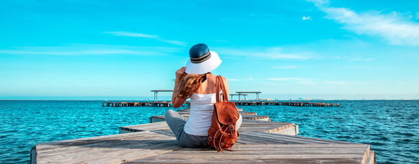 Panorama of Mar Menor lagoon, from Los Alcazares, Murcia, Spain- woman tourist sitting and enjoying...